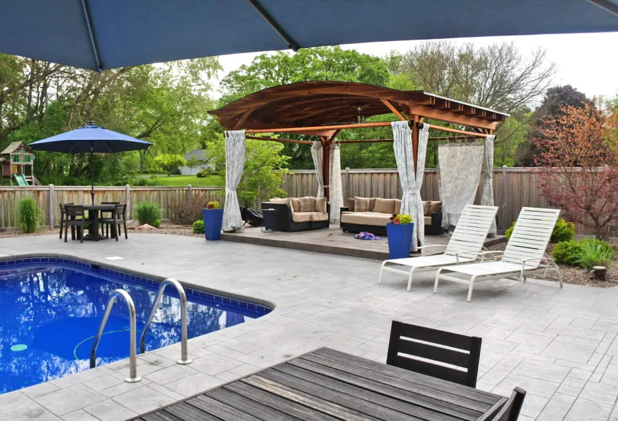 Backyard Pavilion Kits (Options: 15' L x 18' Arc W, California Redwood, 2 Post Electrical Wiring Trims, 4-Post Anchor Kit for Concrete, 1 Ceiling Fan Base, No Privacy Panels, 4 Curtain Rods, 9 ft Post Height, Transparent Premium Sealant). Photo Courtesy of S. McDonald of Lake Barrington, Illinois.