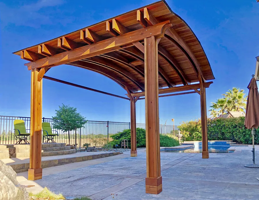 Backyard Pavilion Kits (Options: 14' L x 22' Arc W, California Redwood, 1 Post Electrical Wiring Trim, 4-Post Anchor Kit for Concrete, With 2 Ceiling Fan Bases, No Privacy Panels, 2 Curtain Rods, 9.5 ft Post Height, Transparent Premium Sealant). Photo Courtesy of T. Bauer of Sacramento, CA.