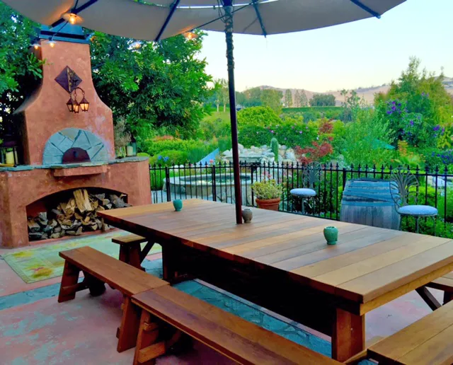 Baja Outdoor Redwood Dining Table (Options: 10 ft L, 48 inches W, Side & End Benches, 2 Half Benches Per Side, California Redwood, Standard Tabletop, Squared Corners, 2" Umbrella Hole, Transparent Premium Sealant). Photo Courtesy of Arjun Reyes of Santa Rosa Valley, CA.