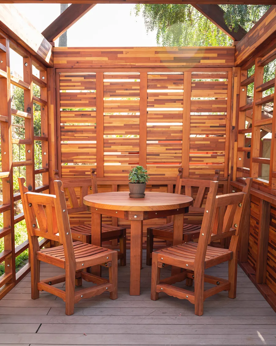 Catalina Island Pergola (Options: 8' x 8', Mosaic Redwood, 8' Post Height, Transparent Premium Sealant). Photo Also Shows a Round Patio Table with Segovia Chairs.