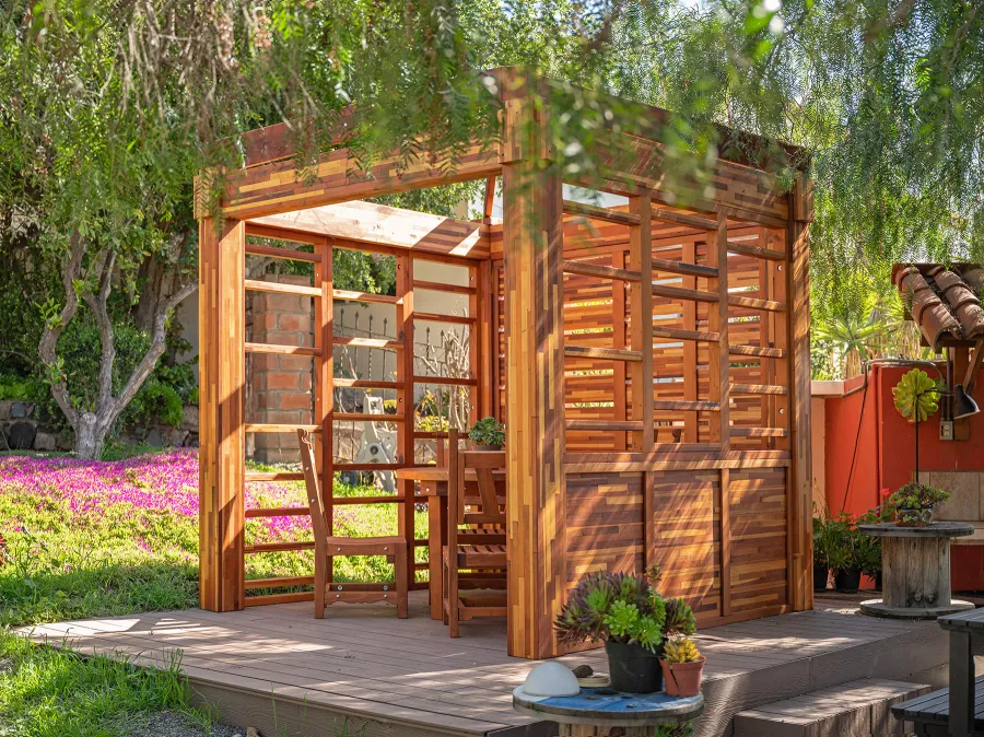 Catalina Island Pergola (Options: 8' x 8', Mosaic Redwood, 8' Post Height, Transparent Premium Sealant). Photo Also Shows a Round Patio Table with Segovia Chairs.