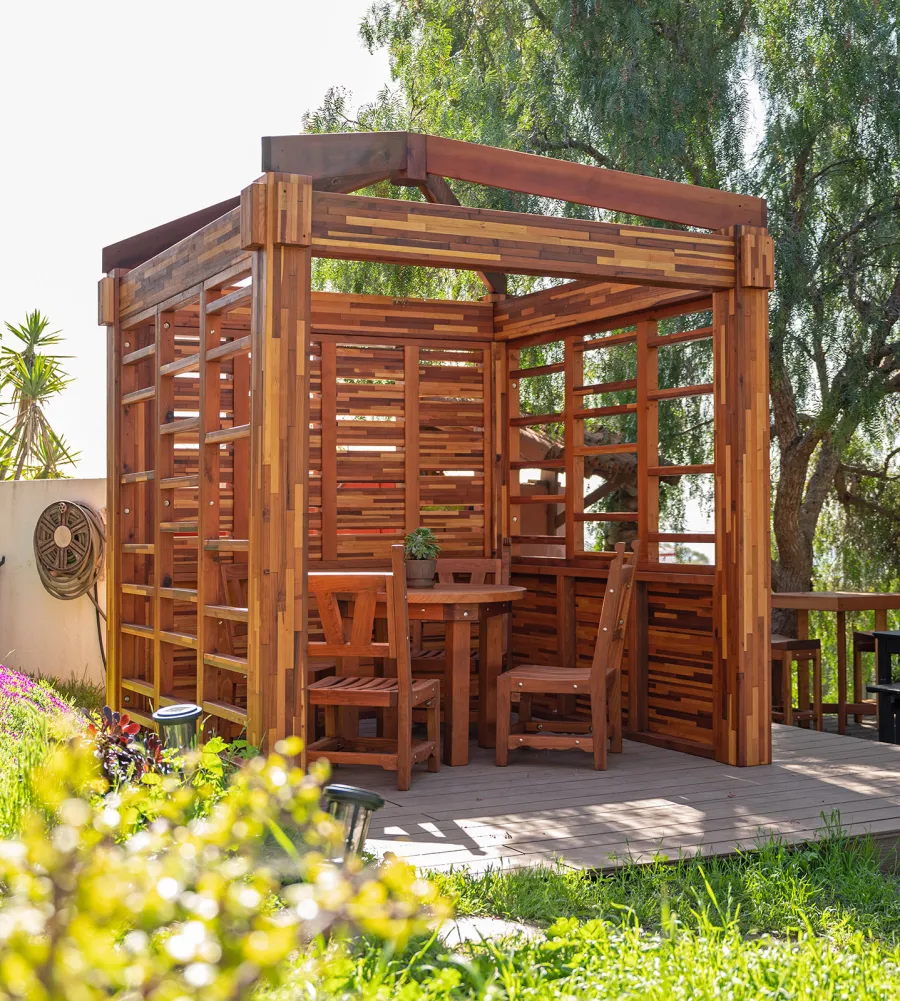 Catalina Island Pergola (Options: 8' x 8', Mosaic Redwood, 8' Post Height, Transparent Premium Sealant). Photo Also Shows a Round Patio Table with Segovia Chairs.