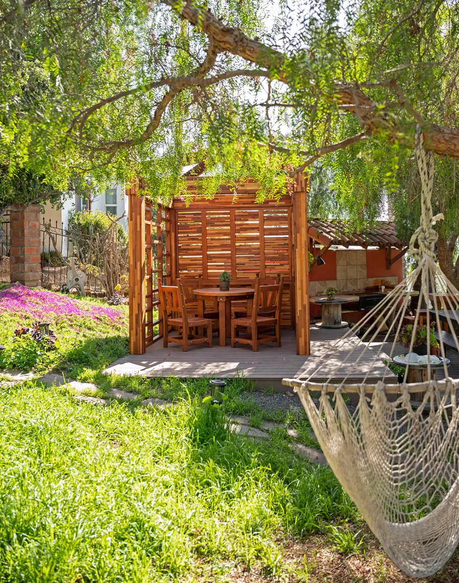 Catalina Island Pergola (Options: 8' x 8', Mosaic Redwood, 8' Post Height, Transparent Premium Sealant). Photo Also Shows a Round Patio Table with Segovia Chairs.
