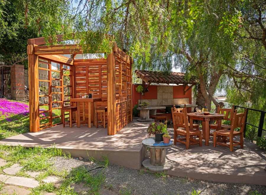 Catalina Island Pergola (Options: 8' x 8', Mosaic Redwood, 8' Post Height, Transparent Premium Sealant). Photo Also Shows a Glady's Table Under the Pergola and a Round Patio Table with Segovia Chairs.