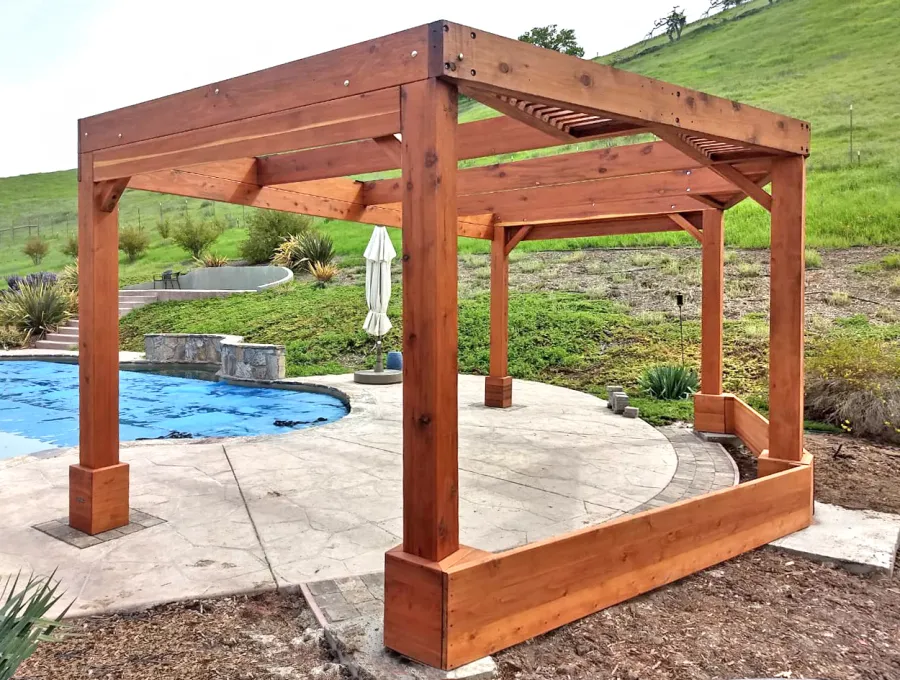 Custom Wooden Pergola (Options: 20' x 12', Mature Redwood, Posts Anchor Kit for High-Wind, Transparent Premium Sealant). Photo Courtesy of D. Ruprecht of Hollister, CA.