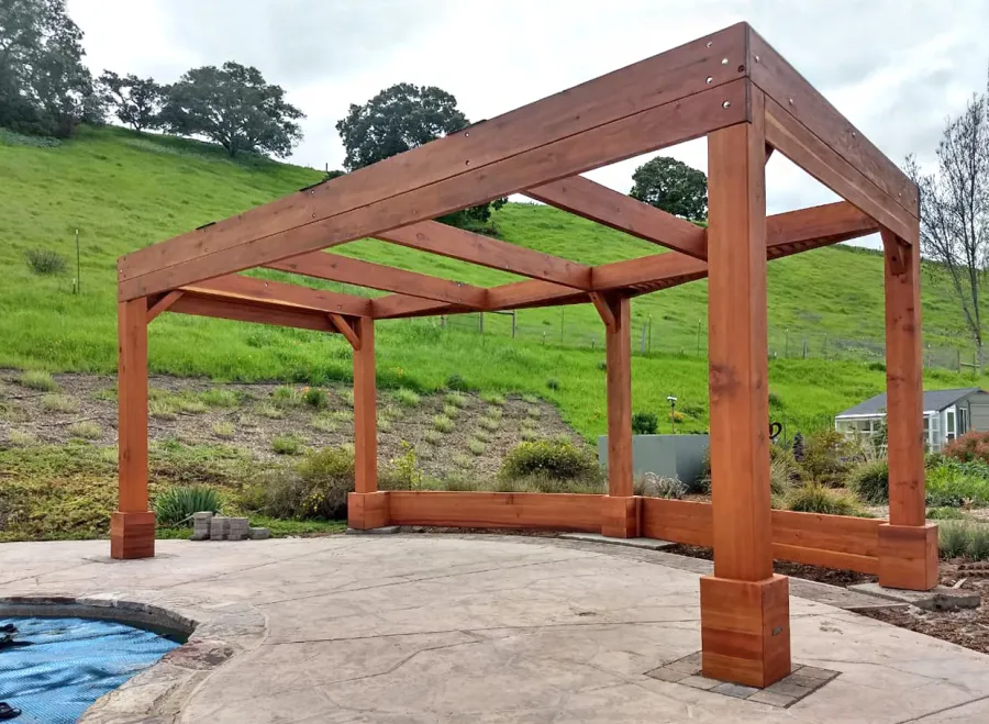 Custom Wooden Pergola (Options: 20' x 12', Mature Redwood, Posts Anchor Kit for High-Wind, Transparent Premium Sealant). Photo Courtesy of D. Ruprecht of Hollister, CA.