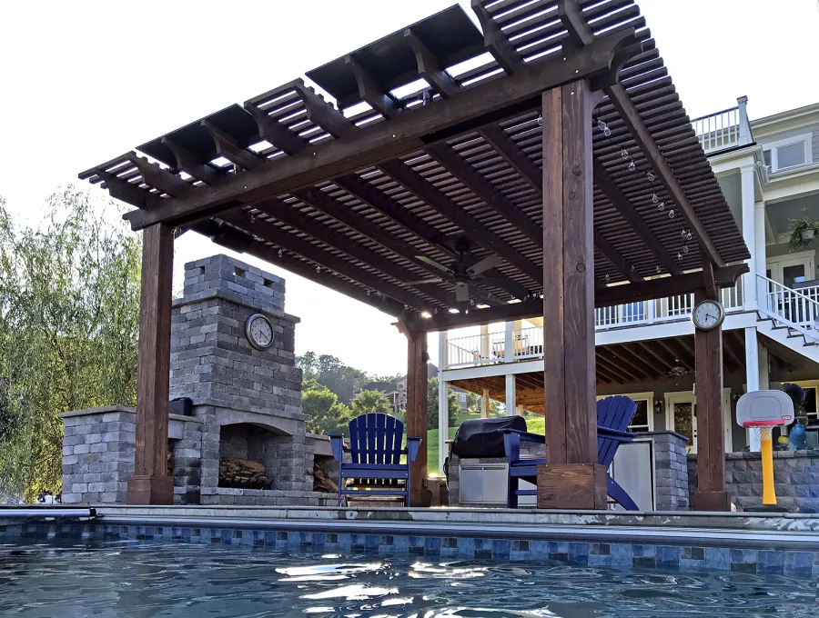 Custom Garden Pergola (Options: 16' L x 16' W, California Redwood, 4-Post Anchor Kit for Concrete, Cherry Stain Premium Sealant). Plumbing was built into the timbers to create a waterfall. Photo Courtesy of D. Hogan of Charlottesville, Virginia.