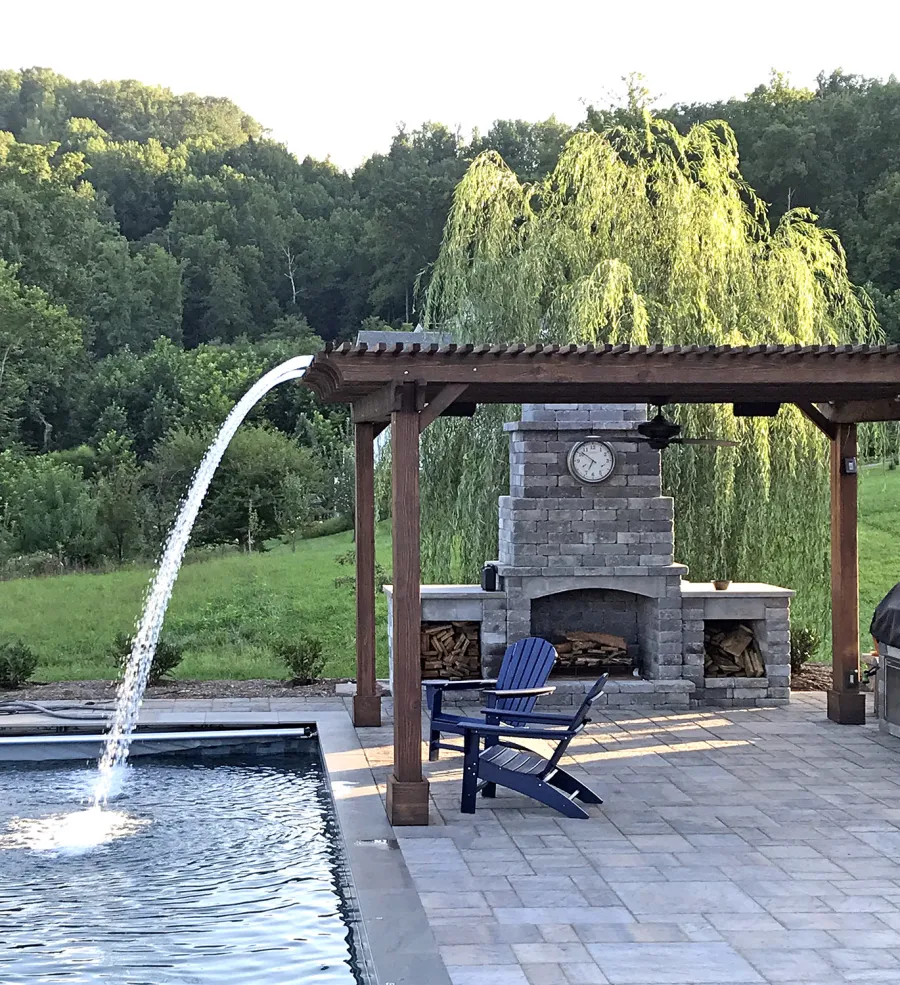 Custom Garden Pergola (Options: 16' L x 16' W, California Redwood, 4-Post Anchor Kit for Concrete, Cherry Stain Premium Sealant). Plumbing was built into the timbers to create a waterfall. Photo Courtesy of D. Hogan of Charlottesville, Virginia.