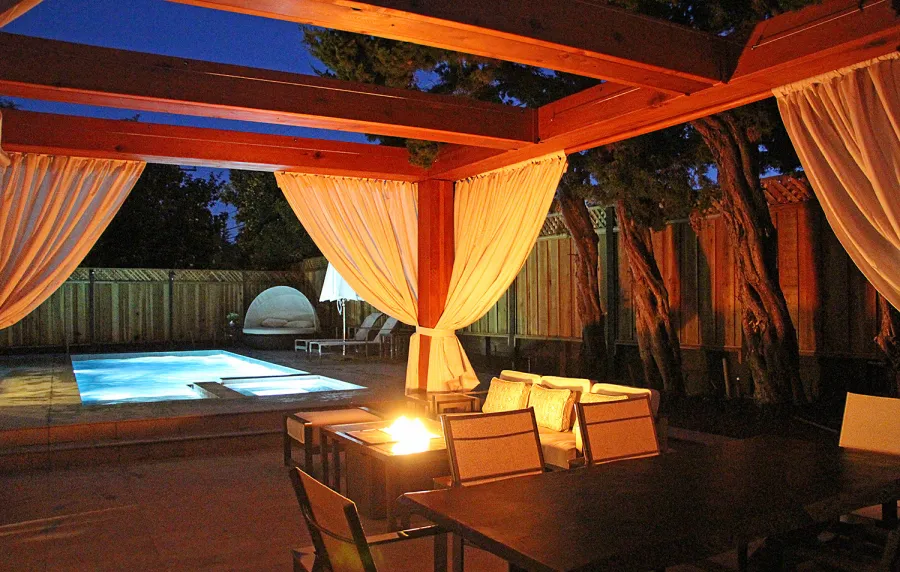 Custom Wooden Fat Timber Pergola (Options: 20' L, 16' W, Old-Growth Redwood, 4 Electrical Wiring Trims, with 2 3/4" x 11 1/4" Roof Timbers and 11 1/4" x 11 1/4" Posts, 4-Post Anchor Kit for High-Wind, No Privacy Panels, Curtain Rods on 4 sides, 10' Post Height, Transparent Premium Sealant). Retractable Canopy designed in cooperation with Infinity Canopy of Los Angeles, CA (www.infinitycanopy.com). Once you have your design finalized, you can forward your drawings to Infinity to add the perfect retractable canopy solution for maximum shade versatility! Photo Courtesy of Darren & Elva Linscott of San Jose, CA.