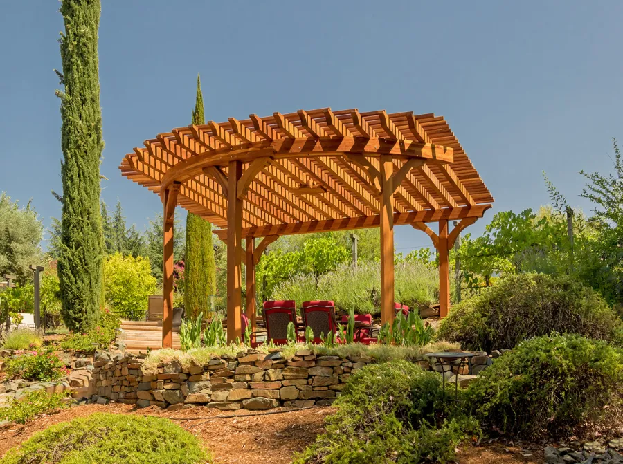 Custom Wooden Pergola (Options: 17' L x 17' W, California Redwood, Electrical Wiring Trim for 1 Post, 5-Post Anchor Kit for Concrete, No Ceiling Fan Base, No Privacy Panels, No Curtain Rods, Transparent Premium Sealant). Photo Courtesy of K. Drahmann of El Dorado Hills, CA.