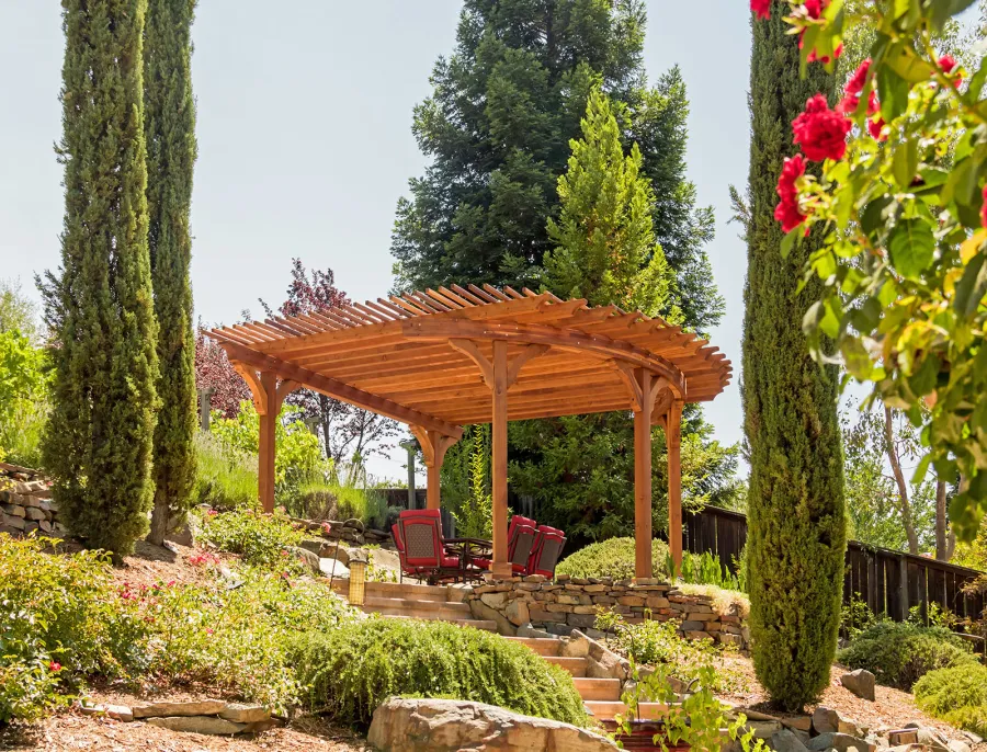 Custom Wooden Pergola (Options: 17' L x 17' W, California Redwood, Electrical Wiring Trim for 1 Post, 5-Post Anchor Kit for Concrete, No Ceiling Fan Base, No Privacy Panels, No Curtain Rods, Transparent Premium Sealant). Photo Courtesy of K. Drahmann of El Dorado Hills, CA.