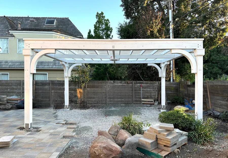 Custom Wooden Pergola (Options: 15' x 20', Douglas-fir, 9.5' H Posts, 8x8 Posts, Electrical Wiring Trim Kit for All Posts, 1 Ceiling Fan Base, Horizontal Decorative Trims for All Posts, Posts Anchor Kit for High-Wind, Off-White Oil-Based Primer). Photo Courtesy of K. Kramer of East Palo Alto, CA.