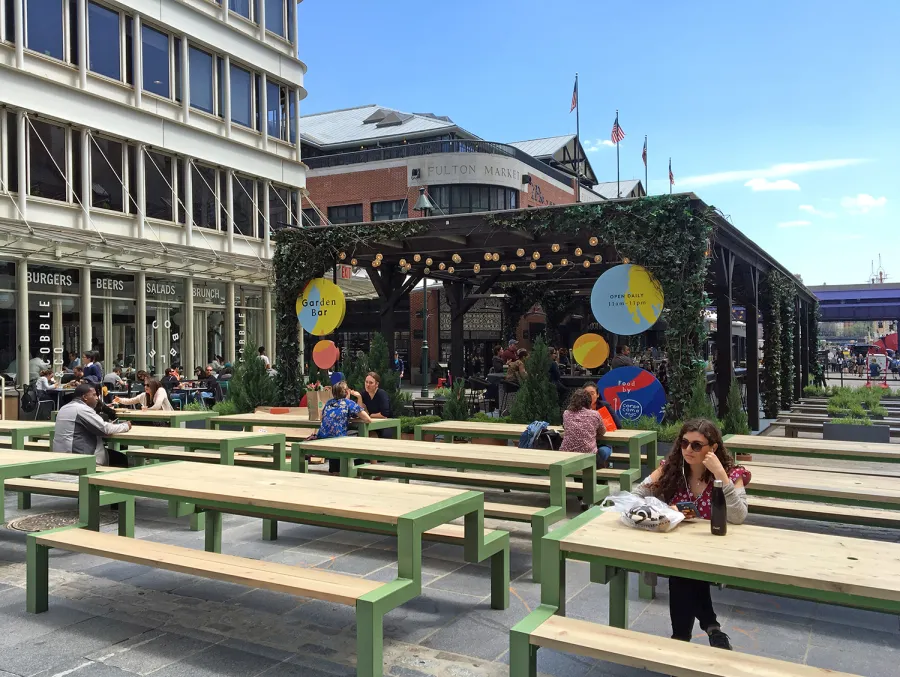 Custom Wooden Pergola (Options: 82' L x 16' W, Douglas-fir, Open Roof with Rafters at 18", with Transparent Rain Guard, 12-Post Anchor Kit, No Ceiling Fan Base, 12' Post Height, Custom Black Paint). This pergola is part of the giant popup beer hall at the Southside Seaport in downtown Manhattan from May to Oct 2017: https://www.timeout.com/newyork/blog/a-giant-pop-up-beer-hall-is-opening-at-south-street-seaport-this-summer-032417