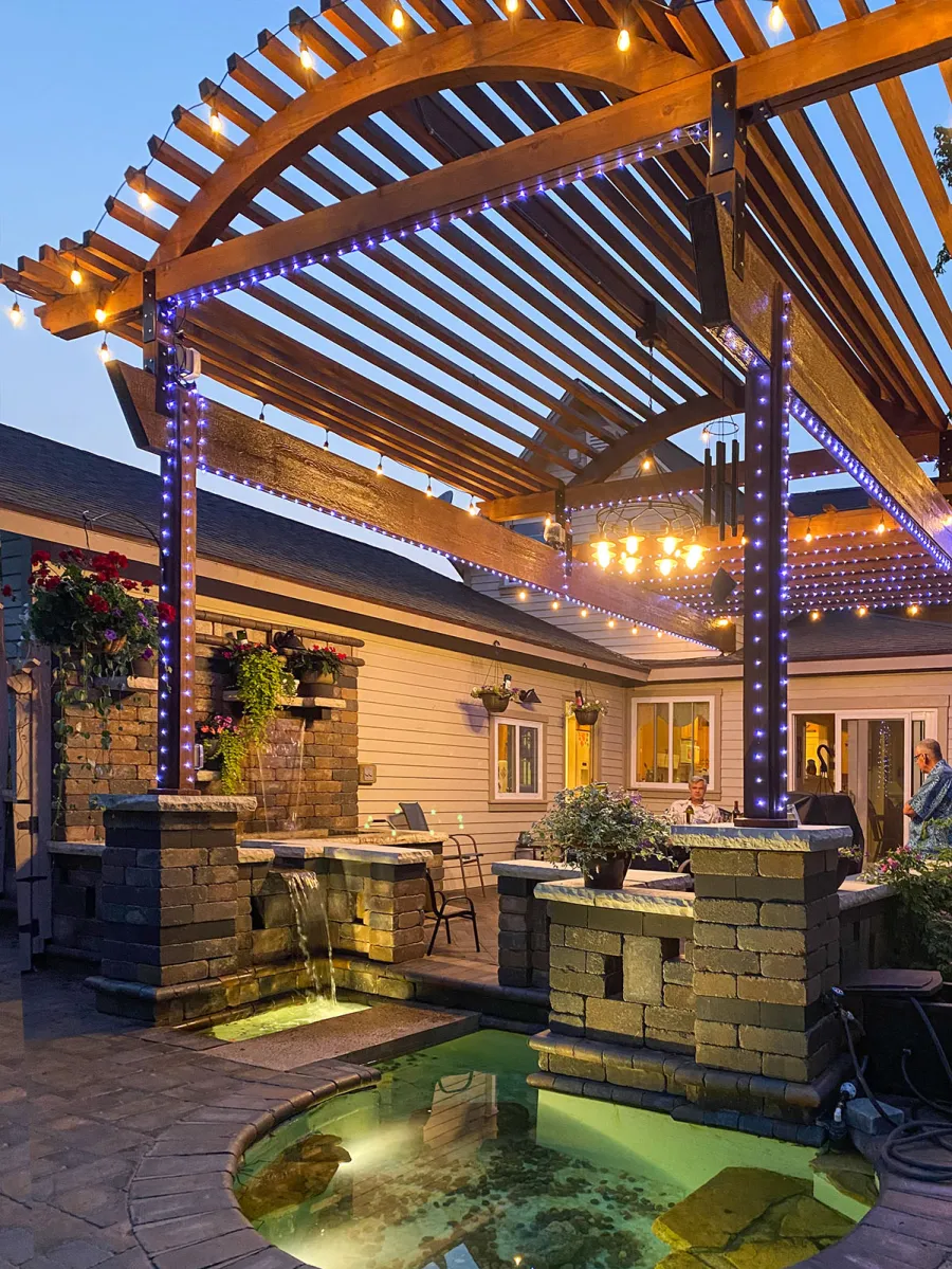 Custom Wooden Pergola (Options: 30' L x 18' W, California Redwood, No Electrical Wiring Trim, Trims to Cover 3 Metal Posts Installed by Customer, Coffee-Stain Premium Sealant). Photo Courtesy of K. Lufkin of Petoskey, Michigan.