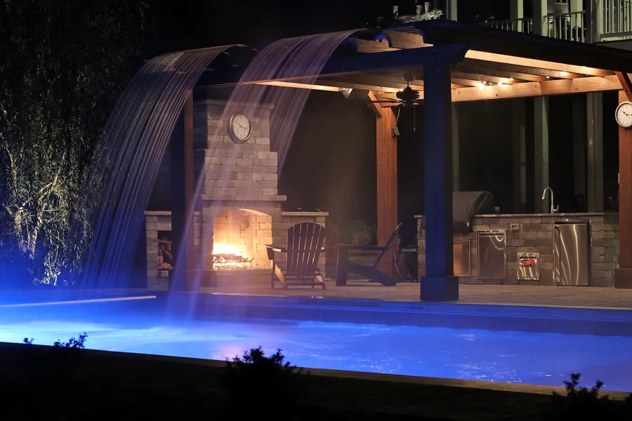 Custom Garden Pergola (Options: 16' L x 16' W, California Redwood, 4-Post Anchor Kit for Concrete, Cherry Stain Premium Sealant). Plumbing was built into the timbers to create a waterfall. Photo Courtesy of D. Hogan of Charlottesville, Virginia.