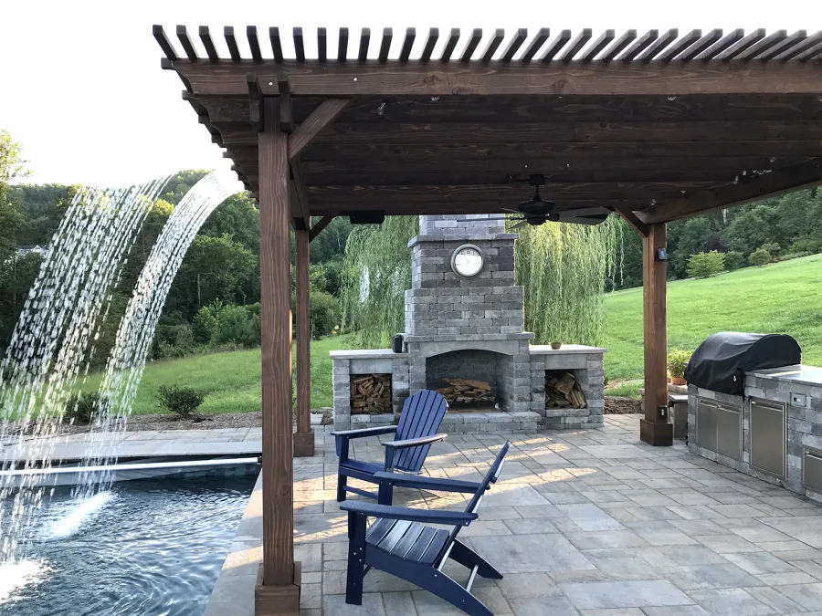 Custom Garden Pergola (Options: 16' L x 16' W, California Redwood, 4-Post Anchor Kit for Concrete, Cherry Stain Premium Sealant). Plumbing was built into the timbers to create a waterfall. Photo Courtesy of D. Hogan of Charlottesville, Virginia.