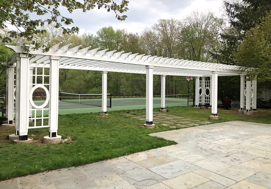 Custom Wooden Fat Timber Pergola (Options: 40' x 18', California Redwood, Posts Anchor Kit for High-Wind, Custom Trellis Between Corner Posts, Off-White Oil-Based Primer). Photo Courtesy of L. Hascoe of Greenwich, CT. Custom copper caps atop all posts.