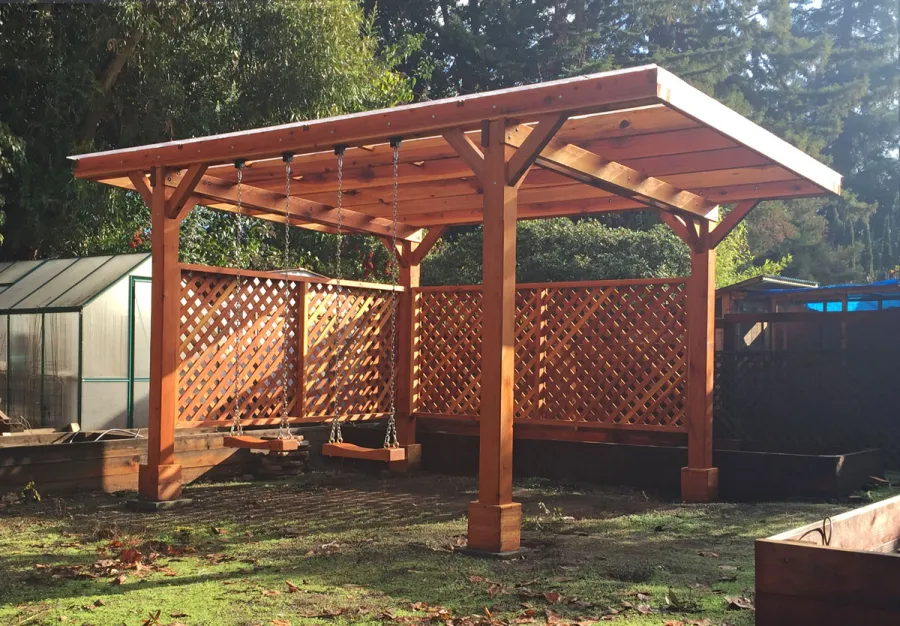 Custom Wooden Pergola (Options: 18' x 15', California Redwood, No Electrical Wiring Trim, Widthwise Roof Supports TImbers, 4-Post Anchor Kit for Stone, 2 Privacy Panels, No Curtain Rods, Roof with a Slope, Transparent Sealant) with 2 Rory's Swing Seats, Added by Custom Request. Customer Added Lexan Panels. Photo Courtesy of Tina Phi of Palo Alto, CA.