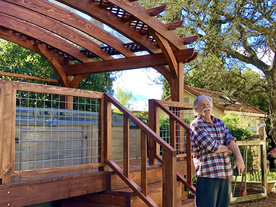 Custom Arched Pergola Kits (Options: 12' L x 22' Arc W, Douglas-fir, Unattached, Electrical Wiring Trim Kit for 1 Post, Arched Roof with Lattice Panels and Acrylic Sheets Centered, 4 Post Anchor Kit for Stone, with 8 x 8 Posts by Custom Request, No Ceiling Fan Base, No Privacy Panels, 1 Curtain Rod, 9' Post Height, Coffee-Stain Premium Sealant) with Custom Deck and Stairs by Custom Request. Photo Courtesy of Steve & Heidi Jones of Windsor, CA.