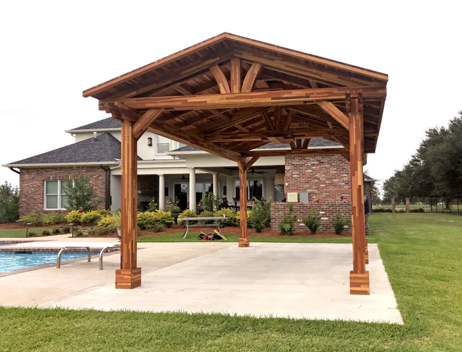 Del Norte Outdoor Kitchen Pavilion (Options: 18' L x 12' W, Mosaic Redwood, 4-Post Anchor Kit for Concrete, 1 Ceiling Fan Base, 2 Electrical Wiring Trim Kits, No Post Decorative Trims, Transparent Premium Sealant). With 5 Posts by Custom Request. Photo Courtesy of A. Bamburg of Natchitoches, Louisiana.