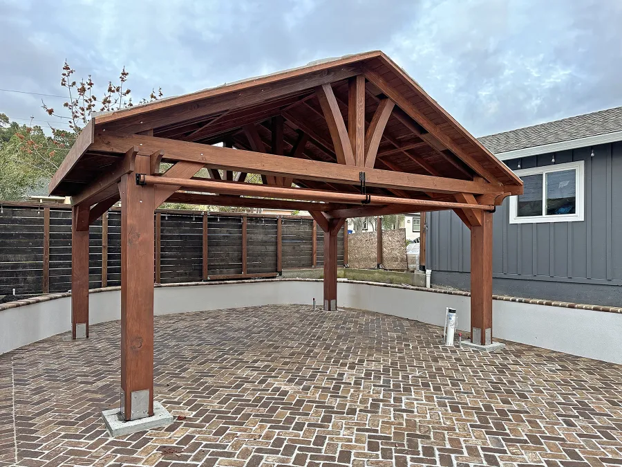 Del Norte Outdoor Kitchen Pavilion (Options: 16' L x 20' W, Douglas-fir, No Privacy Panel, 4-Post Anchor Kit for Concrete, 9' H Posts, 1 Ceiling Fan Base, No Curtain Rod, No Fascia Boards, with 10x10 Posts by Custom Request, Electrical Wiring Trim Kit for 1 Post, Coffee-Stain Premium Sealant). Photo Courtesy of D. Lacau of Napa, CA.