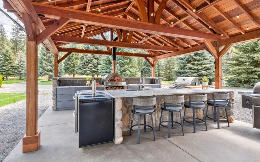 Del Norte Outdoor Kitchen Pavilion (Options: 38.5' L x 18.5' W, California Redwood, No Privacy Panel, Post Anchor Kit for High Wind, 10' H Posts, No Ceiling Fan Base, No Curtain Rod, No Fascia Boards, Transparent Premium Sealant). Photo Courtesy of D. Lemke of Nine Mile Falls, NJ. 