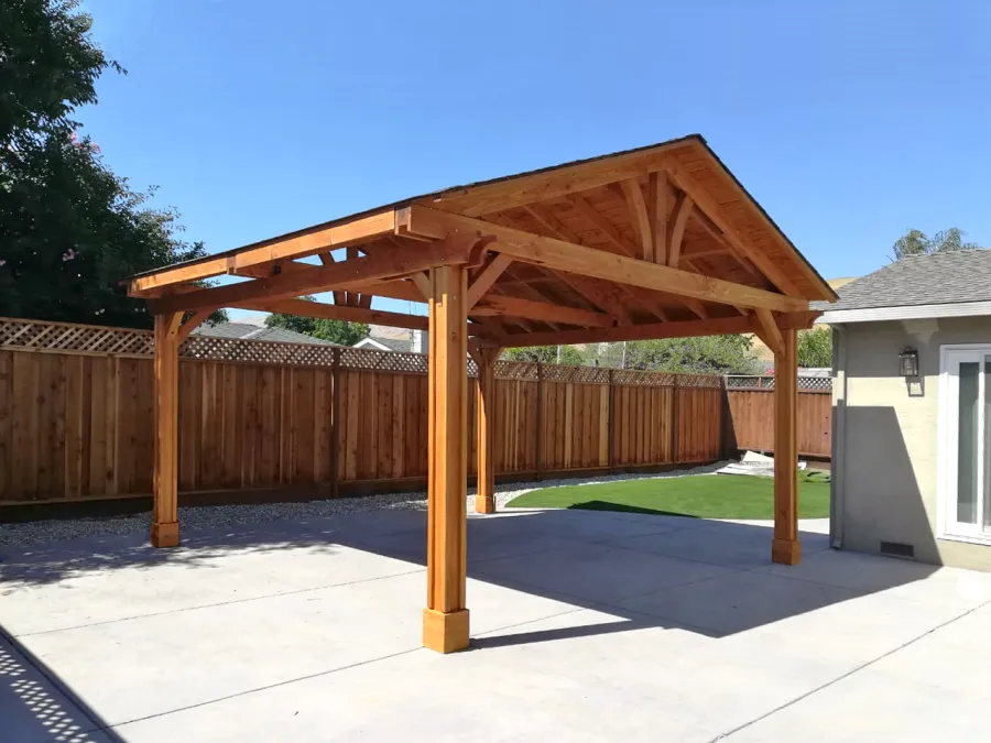 Del Norte Outdoor Kitchen Pavilion (Options: 18' L x 18' W, Douglas-fir, 4-Post Anchor Kit for High-Wind, 1 Ceiling Fan Base, No Electrical Wiring Trim Kit, Vertical Post Decorative Trims, Transparent Premium Sealant). Photo Courtesy of E. Colbert of San Jose, California.