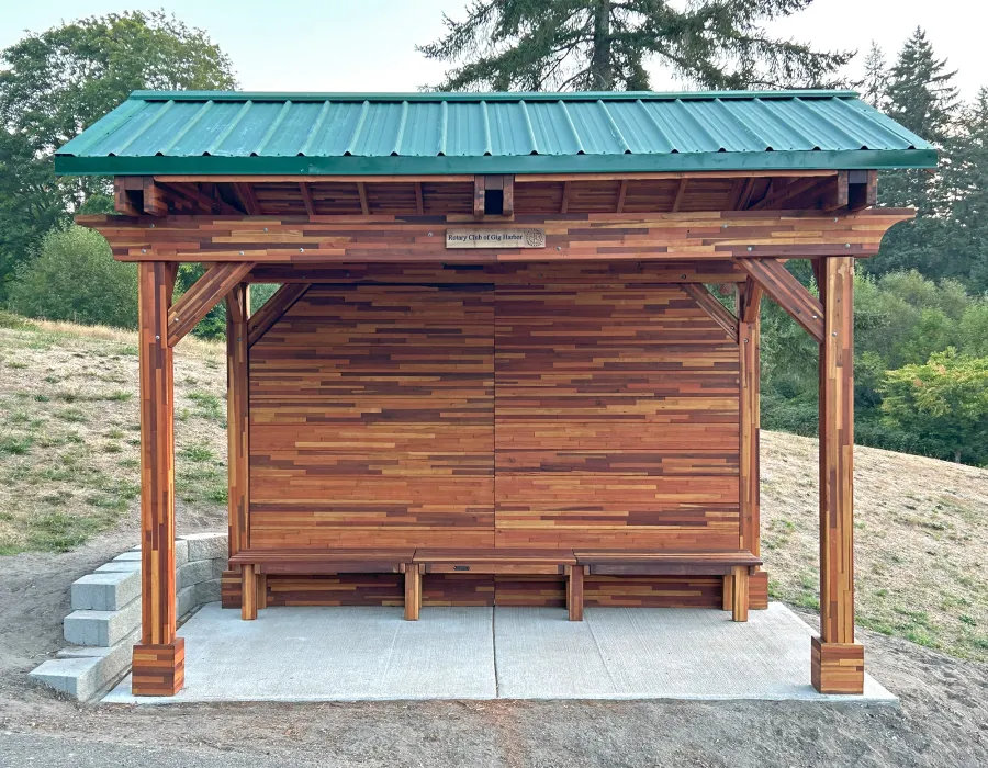 Custom Del Norte Pavilion - Bus Shelter (Options: 14' L x 10' W, Mosaic Redwood, 1 Wall Privacy Panel, Post Anchor Kit for High Wind, 9' H Posts, No Ceiling Fan Base, No Electrical Wiring Trims, No Curtain Rod, Transparent Premium Sealant). Structure Installed at Sehmel Homestead Park in 10123 78th Ave NW, Gig Harbor, WA 98332. , 