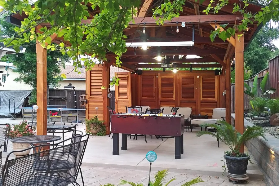 Del Norte Outdoor Kitchen Pavilion (Options: 25' L x 15' W, California Redwood, 6-Post Anchor Kit for Concrete, 4 Ceiling Fan Bases, 2 Electrical Wiring Trim Kits, No Post Decorative Trim, Custom Doors with Louvers & Shutters, Transparent Premium Sealant). Photo Courtesy of J. Gil of San Jose, CA.