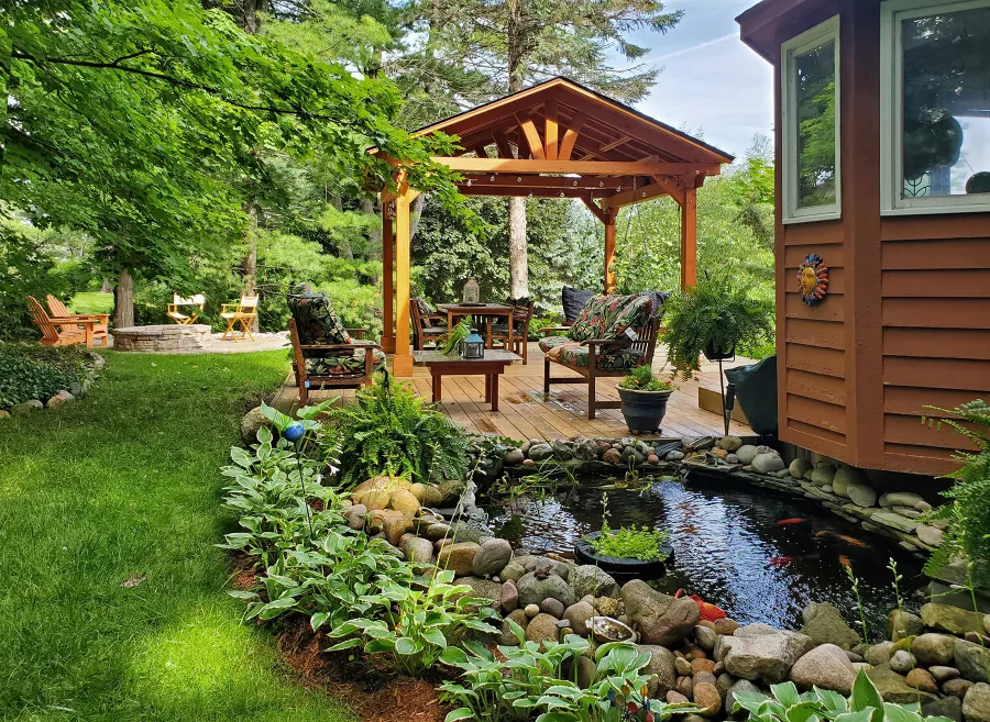 Del Norte Outdoor Kitchen Pavilion (Options: 14' L x 12' W, Douglas-fir, No Privacy Panel, Post Anchor Kit for High Wind, 10' H Posts, No Ceiling Fan Base, No Curtain Rod, Transparent Premium Sealant) with a 6' Jhoola Day Bed Swing. Photo Courtesy of M. Jossens of Traverse City, MI.