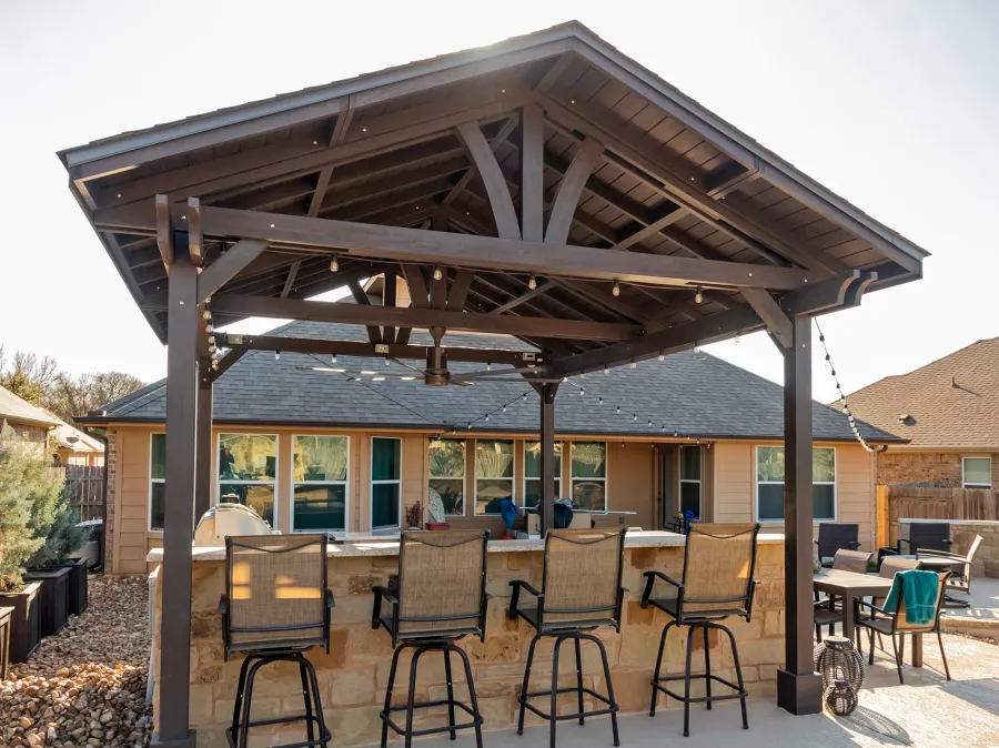 Del Norte Outdoor Kitchen Pavilion (Options: 20' L x 16' W, Mosaic Redwood, 4-Post Kit for Concrete, 1 Ceiling Fan Base, No Electrical Wiring Trim Kit, No Post Decorative Trims, Custom Sealant). Photo Courtesy of S. Oster of Round Rock, TX.