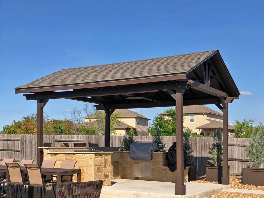Del Norte Outdoor Kitchen Pavilion (Options: 20' L x 16' W, Mosaic Redwood, 4-Post Anchor Kit for Concrete, 10.5' H Posts, 1 Ceiling Fan Base, 2 Fascia Boards, Custom Sealant [Cordovan Brown Solid Color]). Photo Courtesy of S. Oster of Round Rock, Texas.