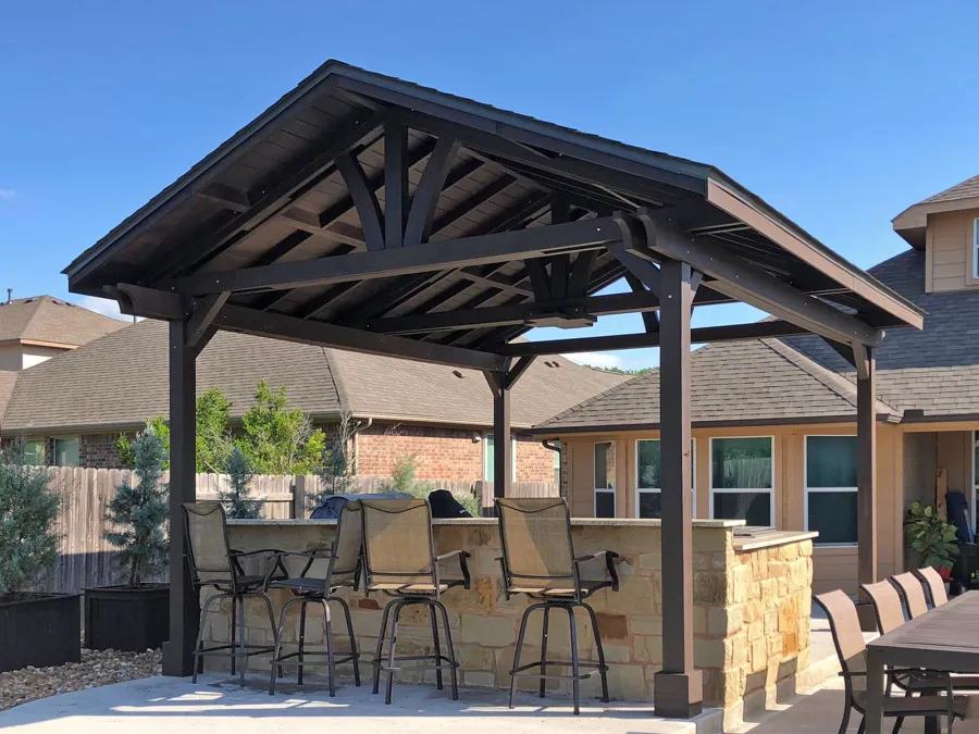 Del Norte Outdoor Kitchen Pavilion (Options: 20' L x 16' W, Mosaic Redwood, 4-Post Anchor Kit for Concrete, 10.5' H Posts, 1 Ceiling Fan Base, 2 Fascia Boards, Custom Sealant [Cordovan Brown Solid Color]). Photo Courtesy of S. Oster of Round Rock, Texas.