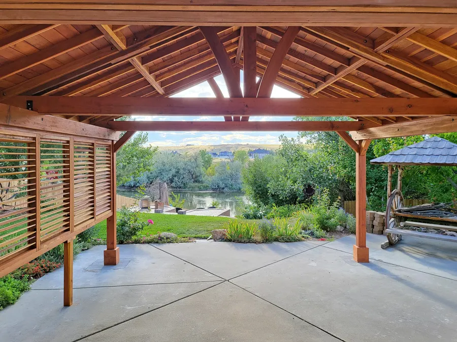 Del Norte Outdoor Kitchen Pavilion (Options: 20' L x 18' W, California Redwood, 1 Louver Privacy Panel Half Height Without Wall, 4-Post Anchor Kit for High-Wind, 9' H Posts, No Ceiling Fan Base, No Fascia Boards, Electrical Wiring Trim Kit for 3 Posts, Transparent Premium Sealant). Photo Courtesy of N. Hodder of Casper, Wyoming.
