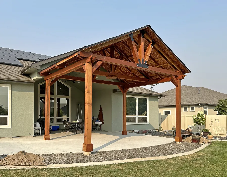 Custom Del Norte Outdoor Kitchen Pavilion (Options: 16' L x 20' W, California Redwood with Tongue and Grove Boards in Mosaic Redwood, No Privacy Panel, Post Anchor Kit for High Wind, 12' H Posts, 1 Ceiling Fan Base, No Electrical Wiring Trim, No Curtain Rod, Transparent Premium Sealant). Photo Courtesy of M. Neideffer of Star, ID.