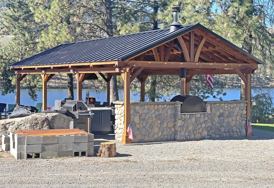 Del Norte Outdoor Kitchen Pavilion (Options: 38.5' L x 18.5' W, California Redwood, No Privacy Panel, Post Anchor Kit for High Wind, 10' H Posts, No Ceiling Fan Base, No Curtain Rod, No Fascia Boards, Transparent Premium Sealant). Photo Courtesy of D. Lemke of Nine Mile Falls, NJ. 