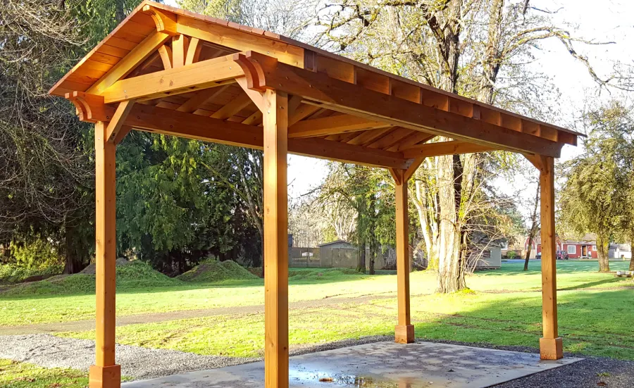 Custom Del Norte Outdoor Kitchen Pavilion (Options: 20' L x 10' W, Douglas-fir, 4-Post Anchor Kit for High-Wind, No Ceiling Fan Base, Transparent Premium Sealant). Larger lumber by custom request. Roofing was still pending when shots taken just after assembly. Photo Courtesy of S. Flanagin of Carnation, WA.