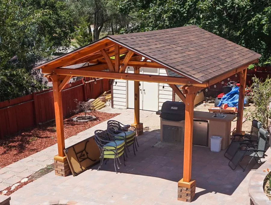 Del Norte Outdoor Kitchen Pavilion (Options: 16' L x 14' W, California Redwood [Mature Redwood Posts], Unattached, 4-Post Anchor Kit for High-Wind, Electrical Wiring Trim for 1 Post, 9.5' Posts, No Ceiling Fan Base, No Privacy Panels, No Curtain Rods, Transparent Premium Sealant). Shingles not Included. Photo Courtesy of K. Hyde of Ogden, Utah.