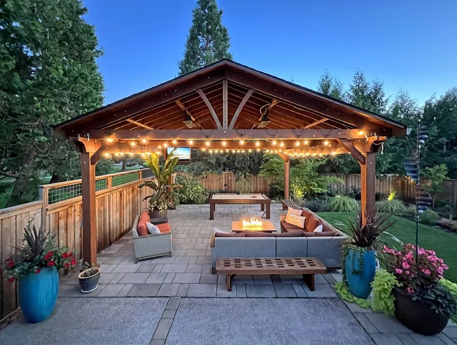 Del Norte Outdoor Kitchen Pavilion (Options: 22' L x 22' W, Mature Redwood, No Privacy Panel, 4-Post Anchor Kit for High-Wind, 9.5' H Posts, 2 Ceiling Fan Bases, 1 Curtain Rod, No Fascia Boards, Electrical Wiring Trim Kit for 2 Posts, Transparent Premium Sealant). Photo Taken 4 Years After Installation. Photo Courtesy of M. Gast of Clackamas, OR.