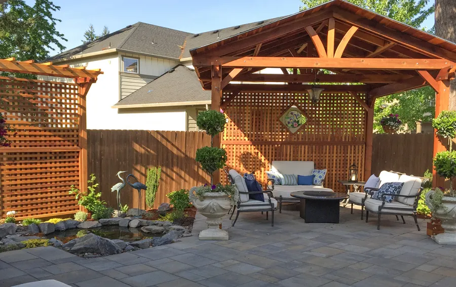 Del Norte Outdoor Kitchen Pavilion (Options: 14' L x 14' W, California Redwood, Unattached, 4-Post Anchor Kit for Concrete, Electrical Wiring Trim for 1 Post, 9' Posts, No Ceiling Fan Base, 2 Custom Privacy Panels, No Curtain Rods, Transparent Premium Sealant). Photo Also Shows a 2 Post Arbor with Custom Privacy Panels. Photo Courtesy of Michael Walti of Hillsboro, Oregon.