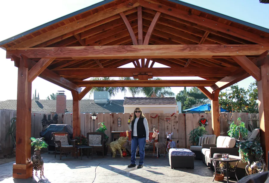 Del Norte Outdoor Kitchen Pavilion (Options: 16' L x 20' W, California Redwood, 4-Post Anchor Kit for High-Wind, With 1 Ceiling Fan Base, Electrical Wiring Trim Kit for 2 Posts, No Post Decorative Trim, Transparent Premium Sealant, 9 1/4" x 9 1/4" Posts & 1 1/2" x 9 1/4" Supports and Rafters by Custom Request). Photo Courtesy of P. Vejar of Merced, CA