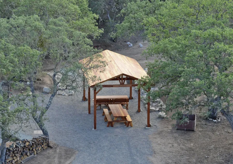 Del Norte Outdoor Kitchen Pavilion (Options: 28' L x 14' W, California Redwood, 6-Post Anchor Kit for Concrete, No Ceiling Fan Base, Transparent Premium Sealant) with 2 Picnic Table Sets with Benches. Photo Courtesy of Russ Dotson of The Oak Hill Ranch in Paicines, CA.