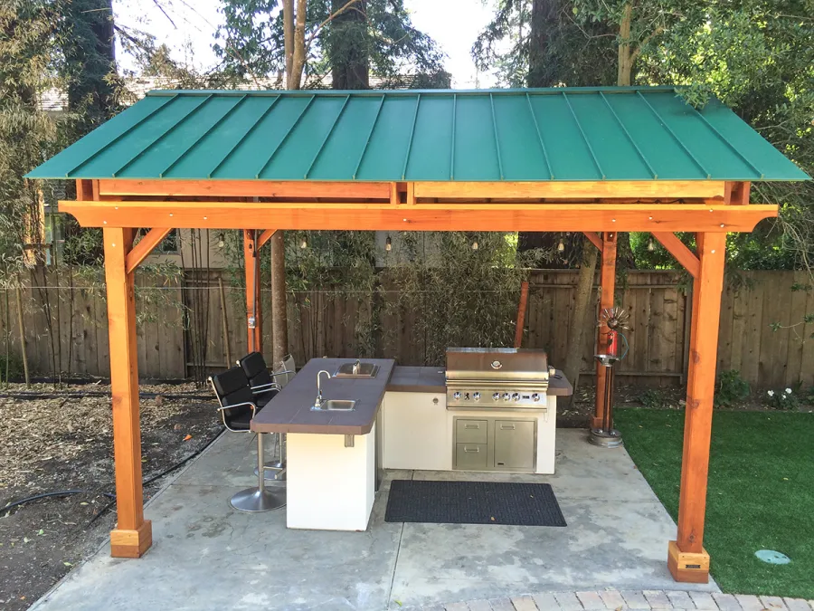 Del Norte Outdoor Kitchen Pavilion (Options: 16' L x 13' W, California Redwood, Unattached, 4-Post Anchor Kit for High-Wind, No Electrical Wiring Trim, 9' Posts, No Ceiling Fan Base, No Privacy Panels, No Curtain Rods, Transparent Premium Sealant). Standing Seam Metal Roof added by Customer Request. Photo Courtesy of Steve Aber of Atherton, CA.