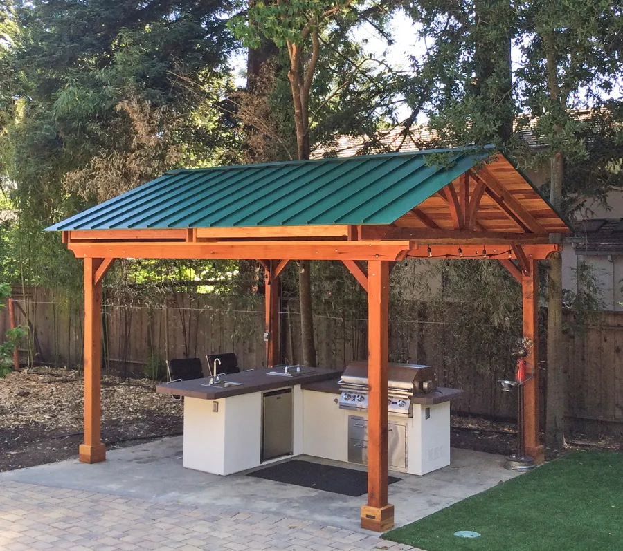 Del Norte Outdoor Kitchen Pavilion (Options: 16' L x 13' W, California Redwood, Unattached, 4-Post Anchor Kit for High-Wind, No Electrical Wiring Trim, 9' Posts, No Ceiling Fan Base, No Privacy Panels, No Curtain Rods, Transparent Premium Sealant). Standing Seam Metal Roof added by Customer Request. Photo Courtesy of Steve Aber of Atherton, CA.