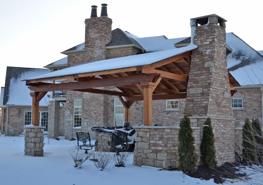 Del Norte Outdoor Kitchen Pavilion (Options: 20' L x 20' W, California Redwood, 4-Post Anchor Kit for High-Wind, 1 Ceiling Fan Base, Transparent Premium Sealant, Custom Cut Out in the Back Overhang to Fit the Fireplace). Photo Courtesy of Tom Mislenkov of Chesterton, Indiana.