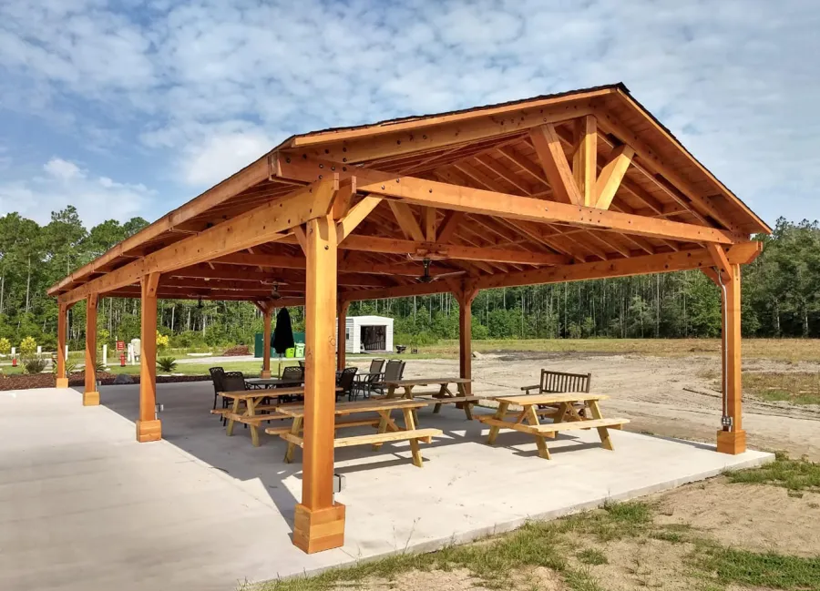 Del Rio Cathedral Ceiling Thick Timber Pavilion (Options: 60' L x 24' W, Douglas-fir, 4-Post Anchor Kit for High-Wind, 3 Ceiling Fan Bases, 8 Electrical Wiring Trim Kit, No Post Decorative Trims, Transparent Premium Sealant). Photo Courtesy of the st. Francis of Assisi Roman Catholic Church Mission of Yulee, FL [86000 St. Francis Way, Yulee, Florida 32097].