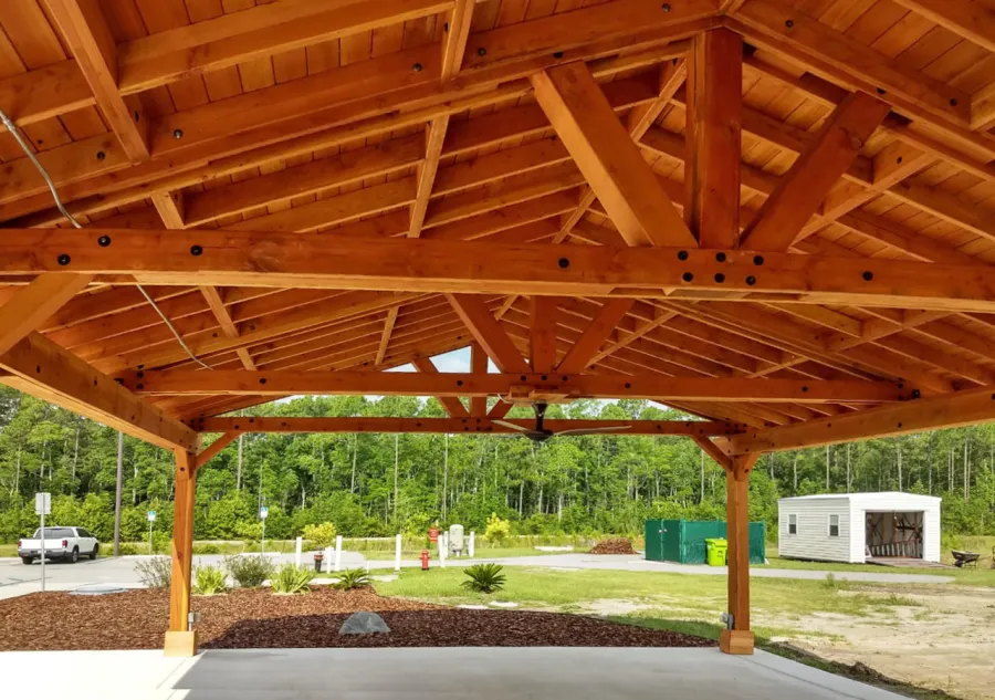 Del Rio Cathedral Ceiling Thick Timber Pavilion (Options: 60' L x 24' W, Douglas-fir, 4-Post Anchor Kit for High-Wind, 3 Ceiling Fan Bases, 8 Electrical Wiring Trim Kit, No Post Decorative Trims, Transparent Premium Sealant). Photo Courtesy of the st. Francis of Assisi Roman Catholic Church Mission of Yulee, FL [86000 St. Francis Way, Yulee, Florida 32097].