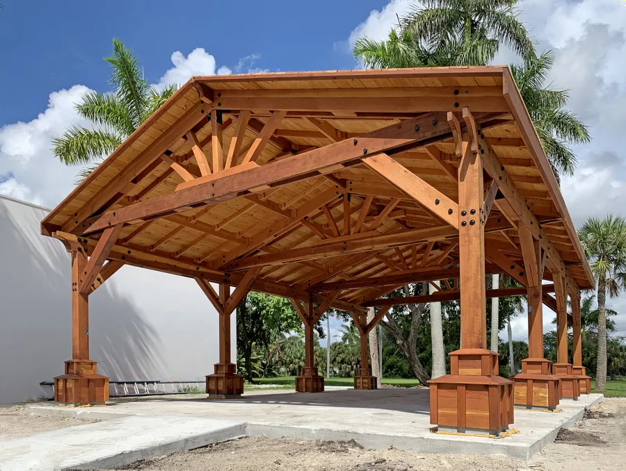 Custom Del Rio Cathedral Ceiling Thick Timber Pavilion (Options: 36' L x 24' Triangle Base W, No Privacy Panels, Douglas-fir, 10' ft Height, Electrical Wiring Trims for All Posts, With Custom Anchors and Hardware, Custom Trim Boxes at the Bottom of the Posts (Boots), 3 Ceiling Fan Bases, No Curtain Rods, Transparent Premium Sealant). This Pavilion can be seen at the South Florida Science Center, 4801 Dreher Trail N, West Palm Beach, FL 33405.