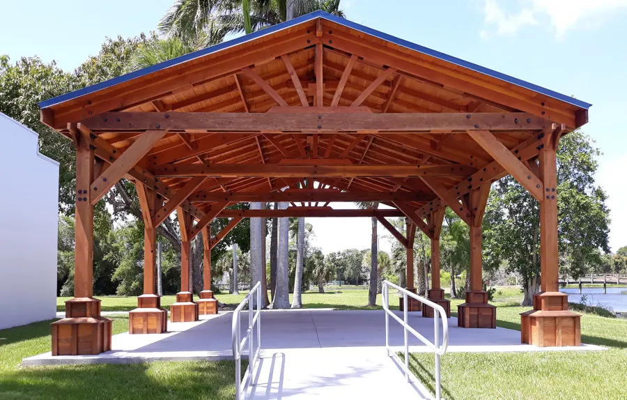 Custom Del Rio Cathedral Ceiling Thick Timber Pavilion (Options: 36' L x 24' Triangle Base W, No Privacy Panels, Douglas-fir, 10' ft Height, Electrical Wiring Trims for All Posts, With Custom Anchors and Hardware, Custom Trim Boxes at the Bottom of the Posts (Boots), 3 Ceiling Fan Bases, No Curtain Rods, Transparent Premium Sealant). This Pavilion can be seen at the South Florida Science Center, 4801 Dreher Trail N, West Palm Beach, FL 33405.