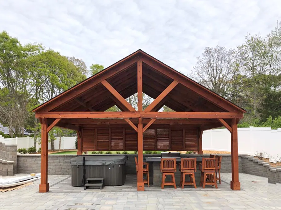 Del Rio Cathedral Ceiling Thick Timber Pavilion  (Options: 18' L x 26' W, California Redwood, 6-Post Anchor Kit for Concrete, Electrical Wiring Trim for 2 Posts, 9.5' Posts, 2 Ceiling Fan Bases, No Privacy Panels, No Curtain Rods, Transparent Premium Sealant, with Extra Knee Braces on the Back by Custom Request). Photo Courtesy of B. Poutre of North Falmouth, Massachusetts.